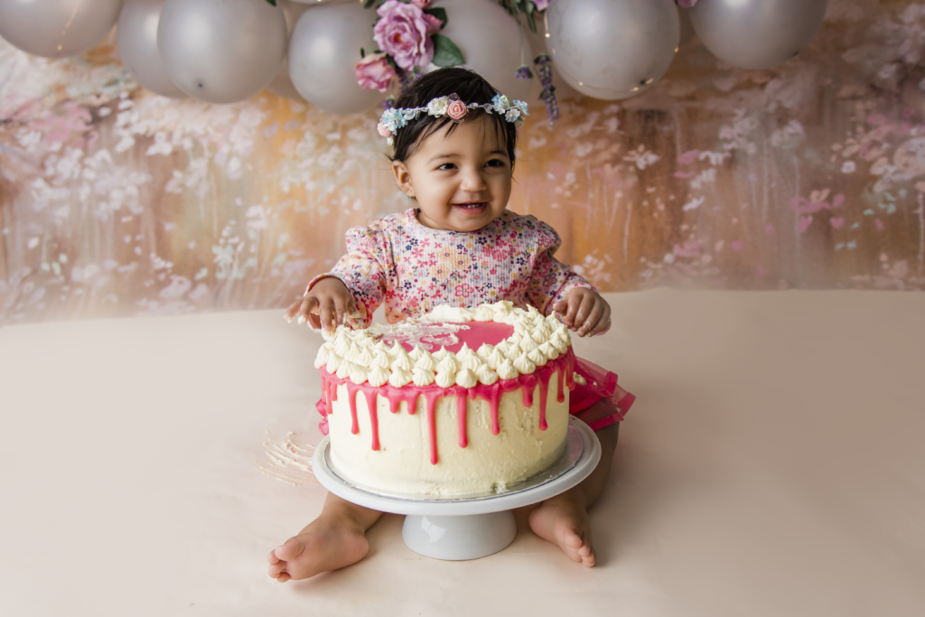 Robina, QLD Cake Smash Photographer pink and cream cake, cake smash, little girl, silver balloon arch