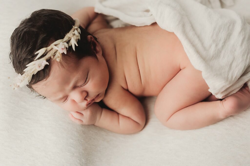 Newborn baby with flower crown posed on bean bag Gold Coast QLD 
